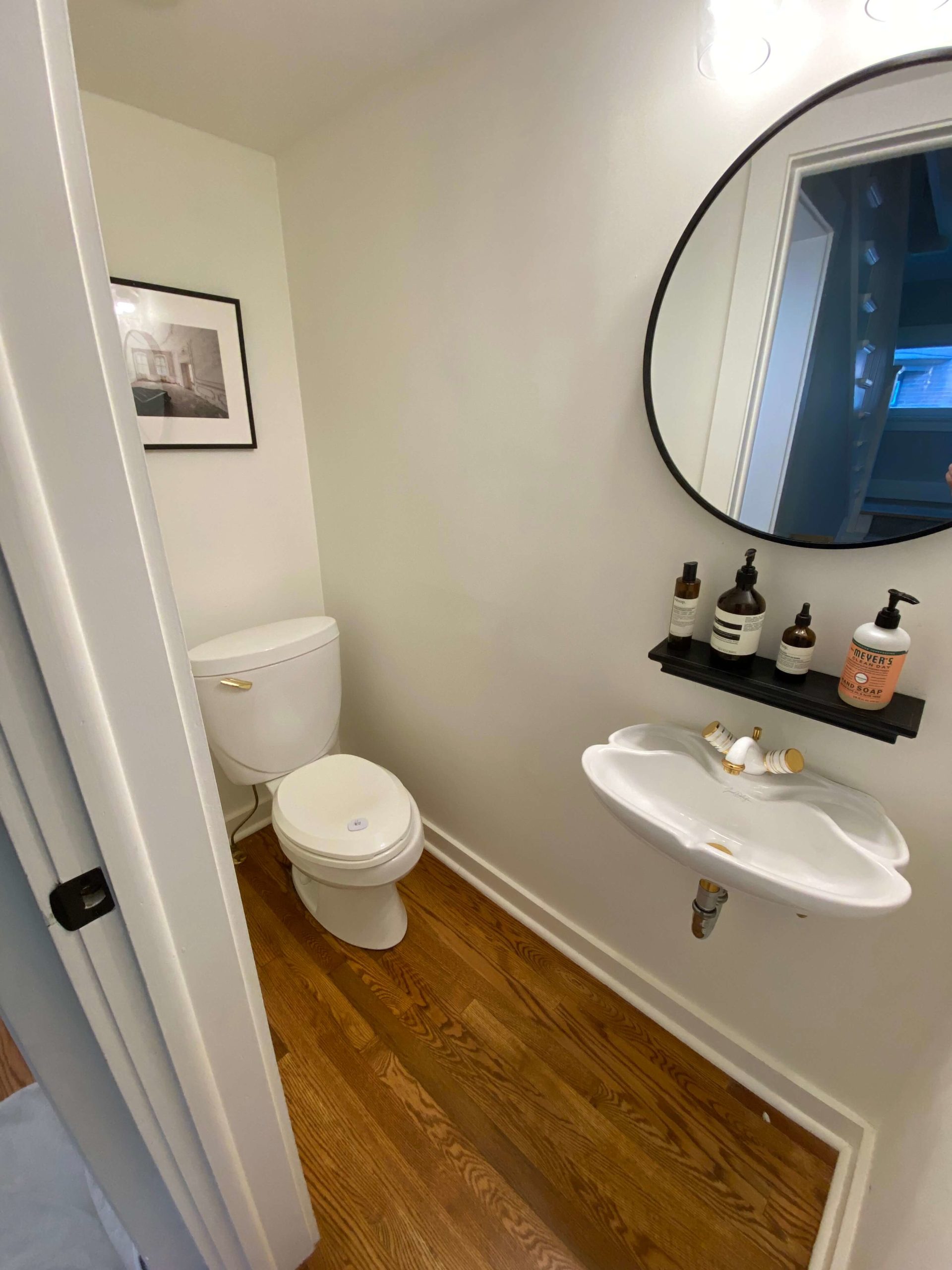 bathroom remodeler - before photo standard floating vanity, and offest toilet in white painted small bathroom