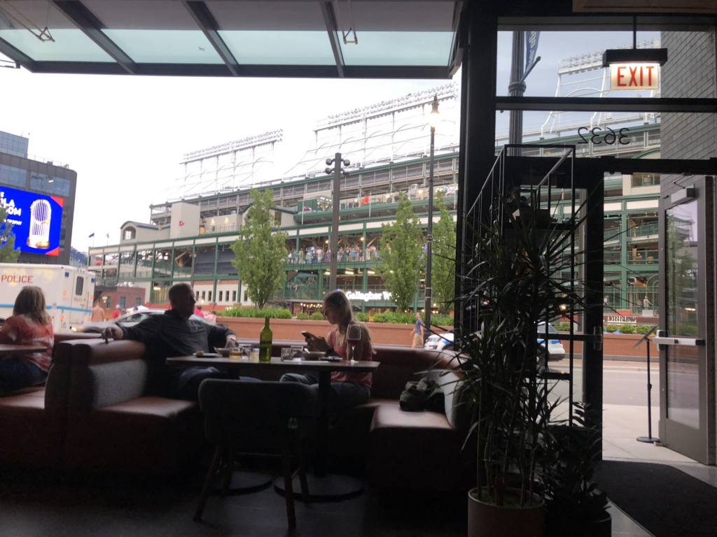 a view of Wrigley field from inside a restaurant in Wrigleyville